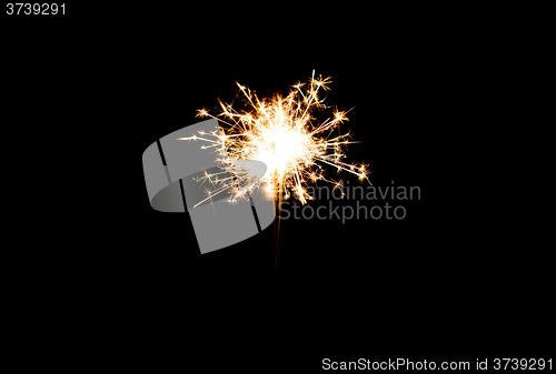 Image of sparkler or bengal light burning over black