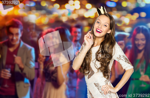 Image of happy young woman or girl in party dress and crown