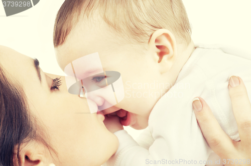 Image of happy mother kissing baby boy