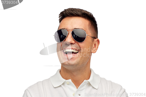 Image of face of smiling man in polo t-shirt and sunglasses