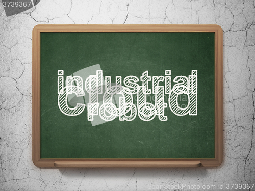 Image of Industry concept: Industrial Robot on chalkboard background