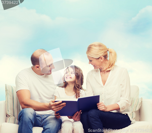 Image of happy family with book at home