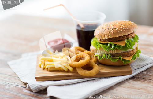 Image of close up of fast food snacks and drink on table