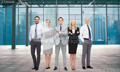 Image of group of smiling businesspeople over office room