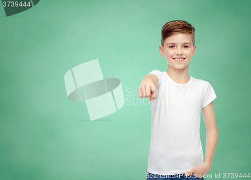 Image of happy boy in white t-shirt pointing finger to you