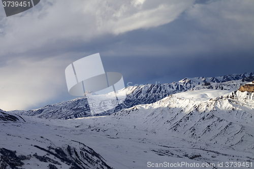 Image of Winter mountains at evening and sunlight clouds