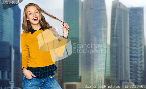 Image of happy young woman or teen girl over city