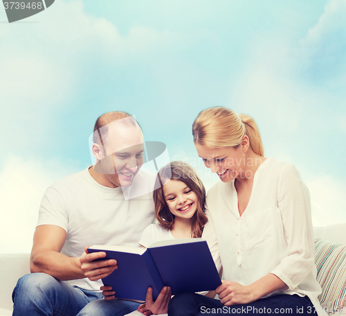 Image of happy family with book at home