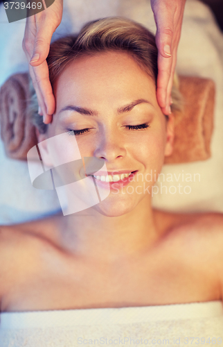 Image of close up of woman having face massage in spa