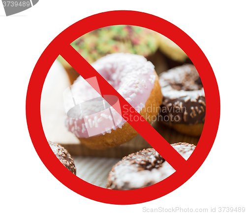 Image of close up of glazed donuts pile behind no symbol