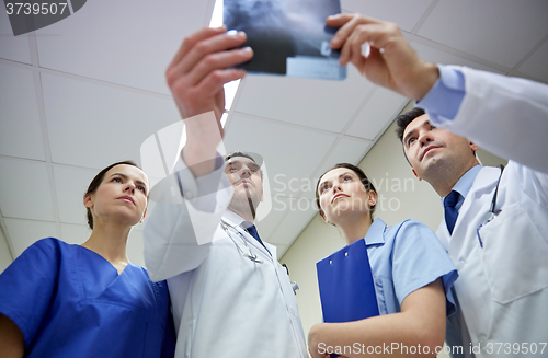 Image of group of doctors looking at x-ray scan image