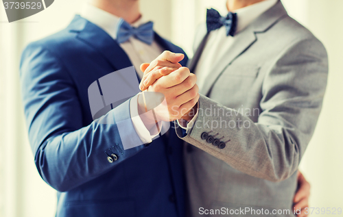 Image of close up of happy male gay couple dancing