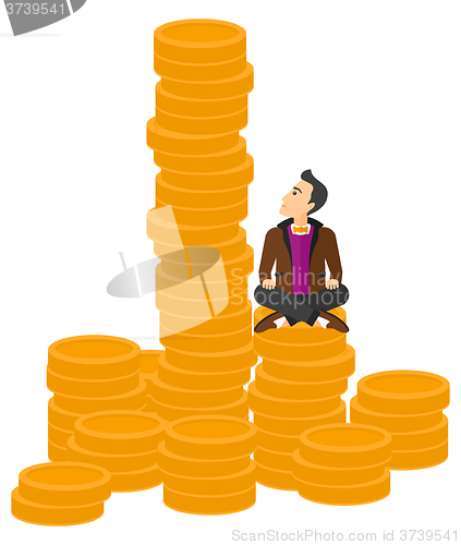 Image of Businessman sitting on gold.