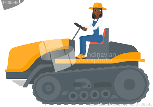 Image of Farmer driving catepillar tractor.