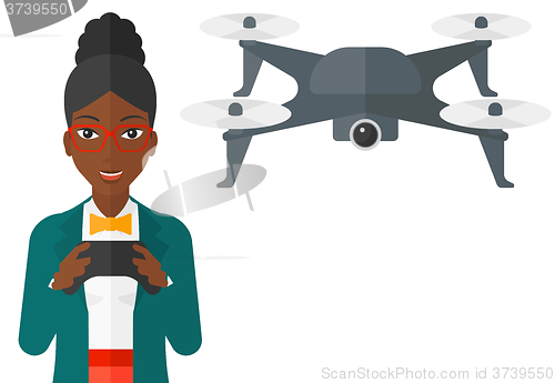 Image of Woman flying drone.