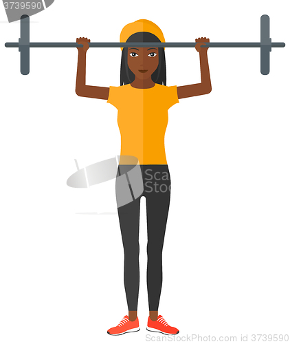 Image of Woman lifting barbell.