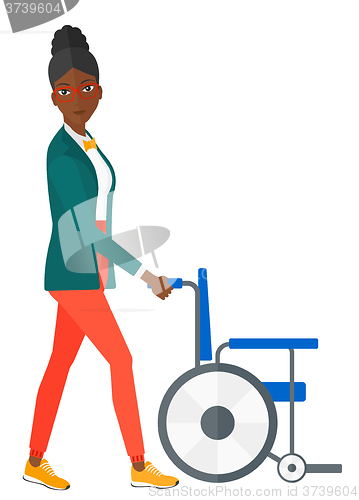 Image of Woman pushing wheelchair.