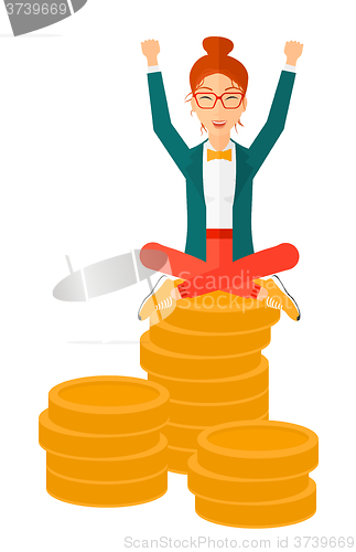 Image of Happy business woman sitting on coins.