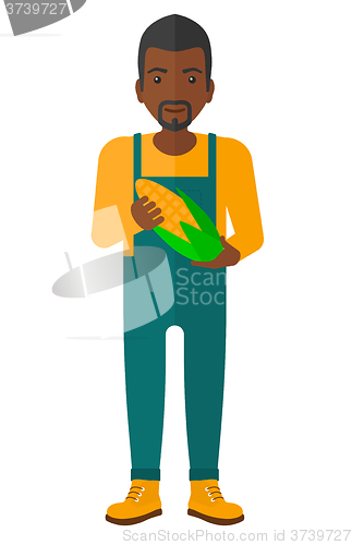 Image of Farmer holding corn.