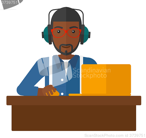 Image of Man working at laptop.
