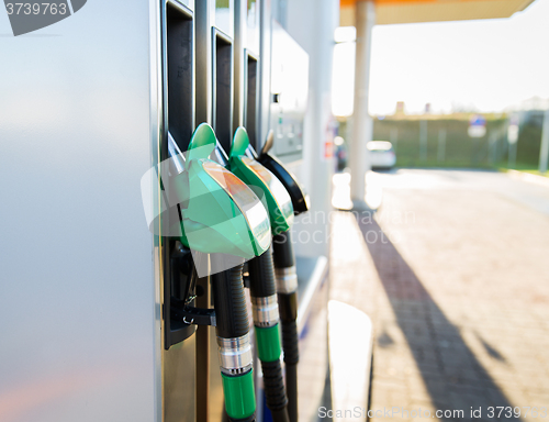 Image of close up of gasoline hose at gas station