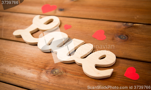 Image of close up of word love with red paper hearts