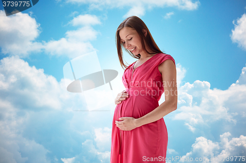 Image of happy pregnant woman with big tummy