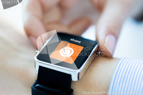 Image of close up of hands setting smartwatch