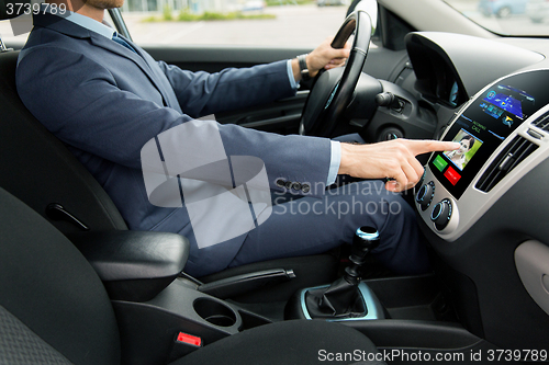 Image of close up of man driving car and incoming call