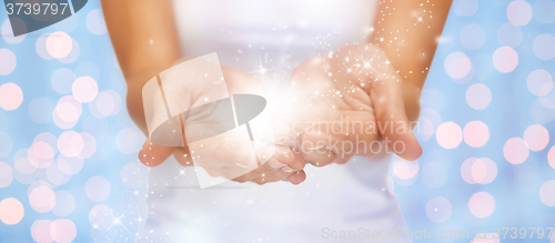 Image of magic twinkles or fairy dust on female hands