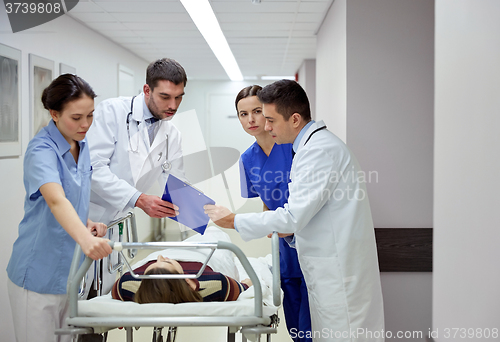 Image of medics and patient on hospital gurney at emergency