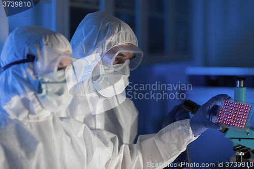 Image of close up of scientists making test in chemical lab
