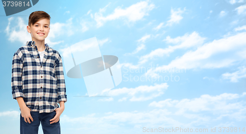 Image of smiling boy in checkered shirt and jeans