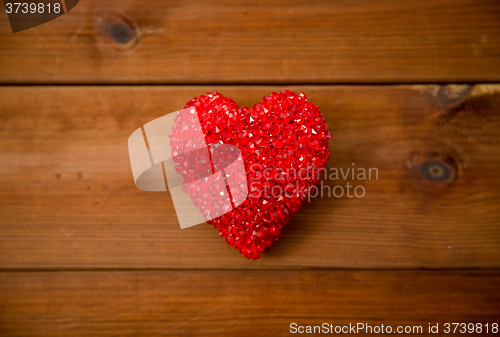 Image of close up of red heart decoration on wood