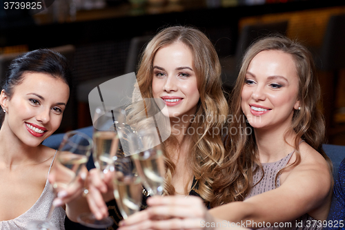 Image of happy women with champagne glasses at night club