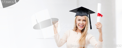 Image of student in graduation cap with certificate