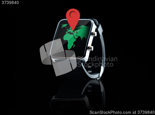 Image of close up of smart watch with world map projection