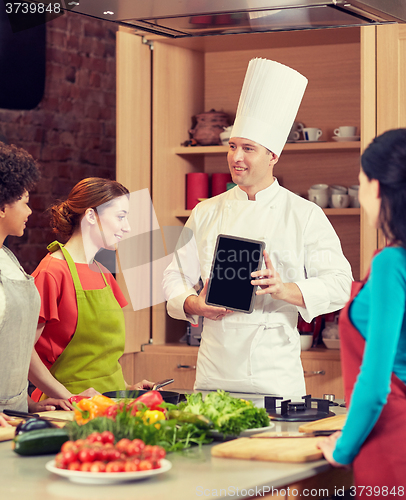 Image of happy women with chef and tablet pc in kitchen