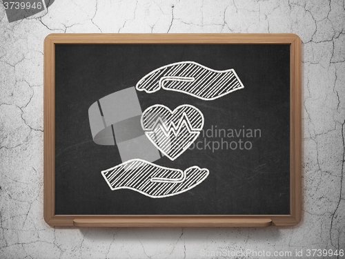 Image of Insurance concept: Heart And Palm on chalkboard background