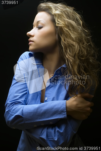 Image of Attractive brunette woman in blue shirt