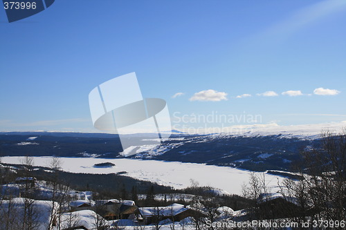 Image of Frozen lake and cabin area