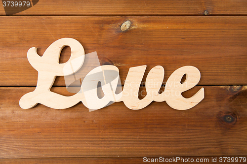 Image of close up of word love cutout on wood