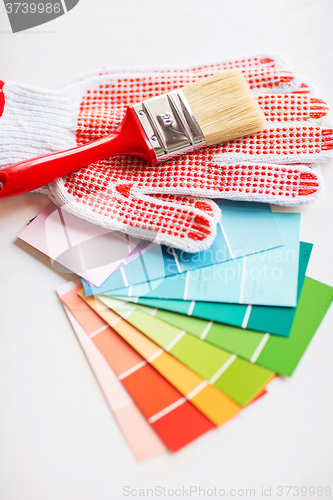 Image of paintbrush, gloves and pantone samplers