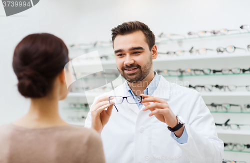 Image of woman and optician showing glasses at optics store