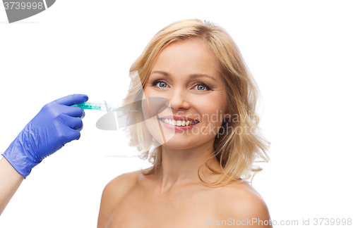 Image of happy woman face and beautician hand with syringe