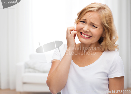 Image of unhappy woman suffering from face inch