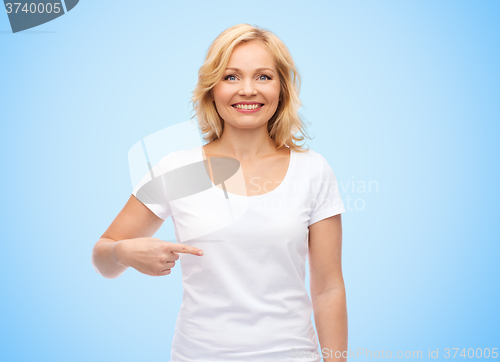 Image of smiling woman in white t-shirt pointing to herself