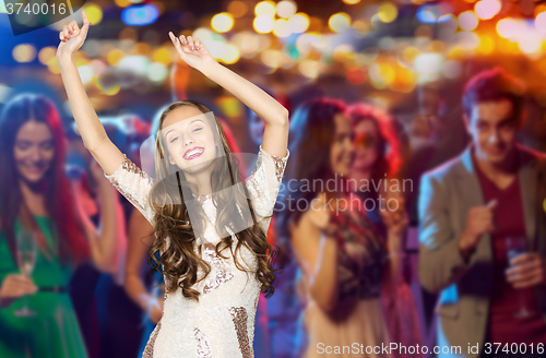 Image of happy young woman or teen dancing at disco club