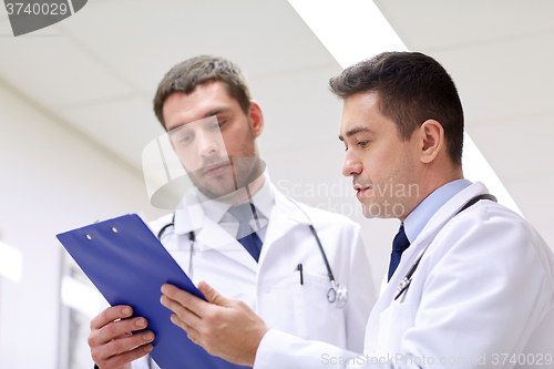 Image of two doctors at hospital with clipboard