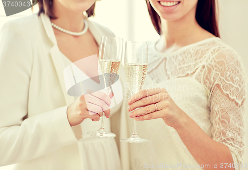 Image of close up of lesbian couple with champagne glasses